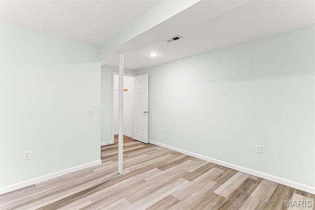 empty room with light wood finished floors, baseboards, and recessed lighting