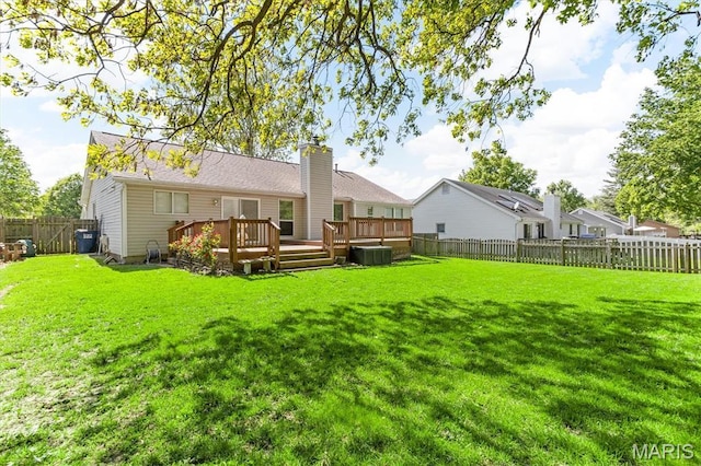 back of property with a deck, central AC, and a chimney