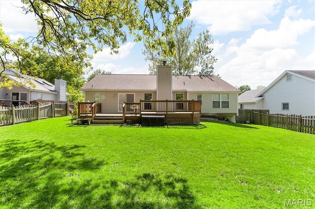 back of property with a wooden deck and a chimney