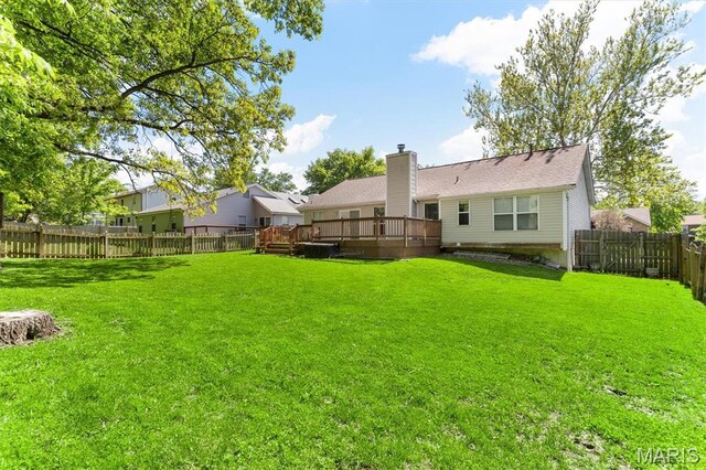 rear view of property featuring a wooden deck and a chimney