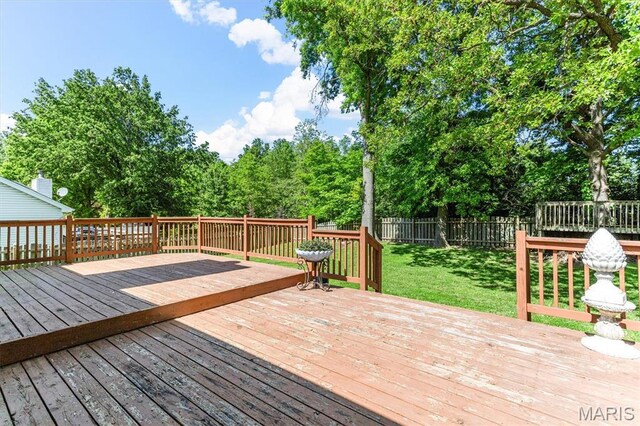 wooden terrace featuring view of scattered trees