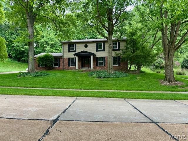 10861 Forest Path Dr, Sunset Hills, MO 63128 - colonial-style house featuring a front lawn and brick siding