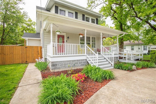 721 Taylor Ave, Godfrey, IL 62035 - view of front of home featuring a porch and fence