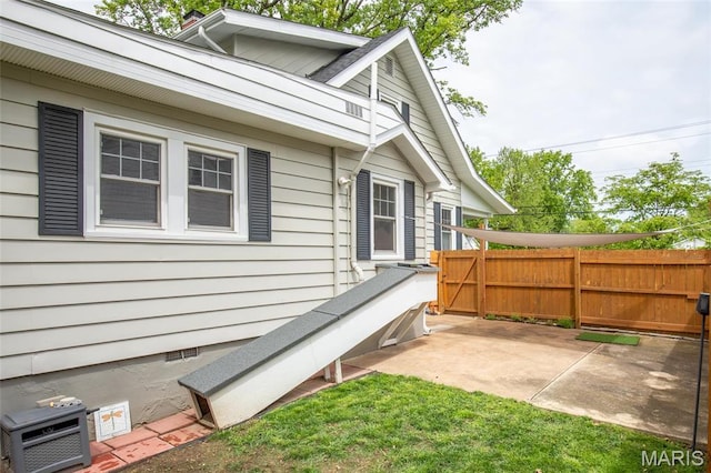 721 Taylor Ave, Godfrey, IL 62035 - view of side of home with fence, a patio, and crawl space