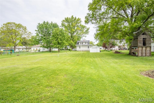 721 Taylor Ave, Godfrey, IL 62035 - view of grassy yard with an outbuilding, a storage unit, and a detached garage