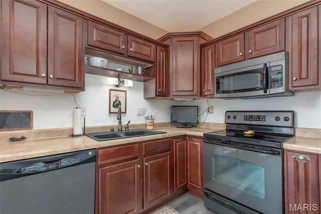 721 Taylor Ave, Godfrey, IL 62035 - kitchen with stainless steel appliances, a sink, light countertops, and light wood-style floors