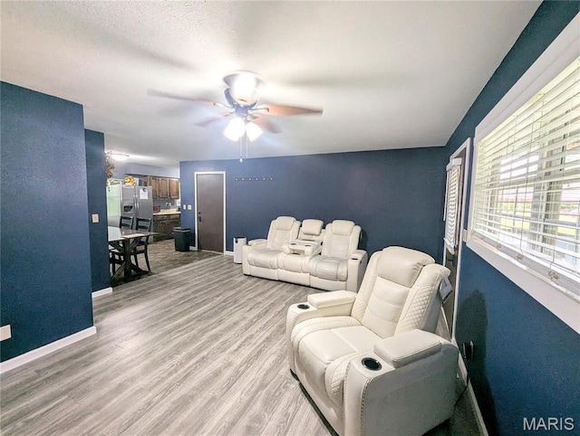 631 W Victor St, Poplar Bluff, MO 63901 - living area with a ceiling fan, light wood finished floors, and baseboards