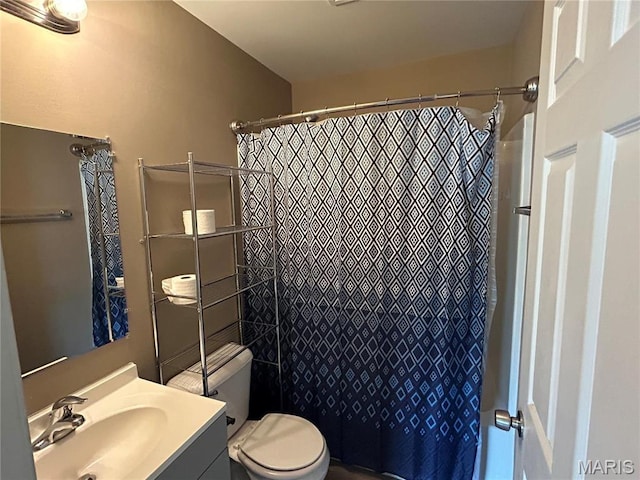 bathroom featuring vanity, toilet, and a shower with shower curtain