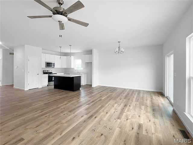 3304 Nat View Ct, Washington, MO 63090 - kitchen featuring appliances with stainless steel finishes, open floor plan, a center island, and a chandelier