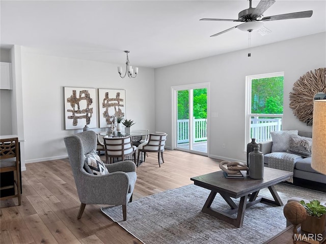 3304 Nat View Ct, Washington, MO 63090 - living area featuring light wood-style flooring, a chandelier, ceiling fan, and baseboards