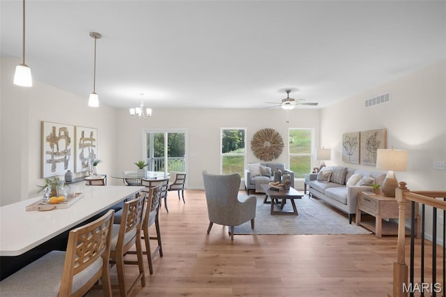3304 Nat View Ct, Washington, MO 63090 - living room with light wood-type flooring, a chandelier, and a ceiling fan