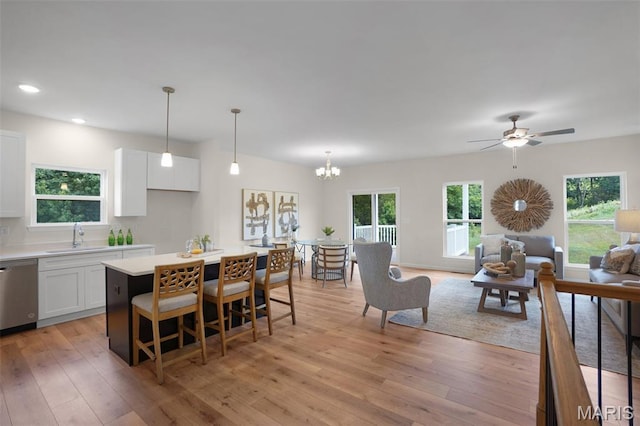 3304 Nat View Ct, Washington, MO 63090 - kitchen featuring dishwasher, open floor plan, white cabinets, light wood finished floors, and recessed lighting
