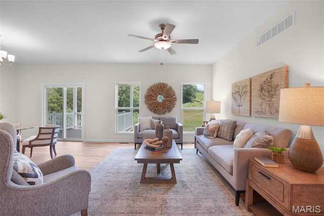 3304 Nat View Ct, Washington, MO 63090 - living room with ceiling fan, wood finished floors, and a chandelier