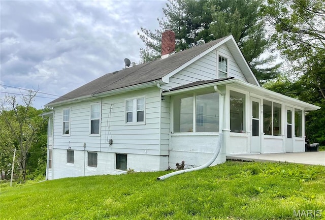 219 2nd St, Winfield, MO 63389 - back of house with a sunroom, a chimney, and a yard