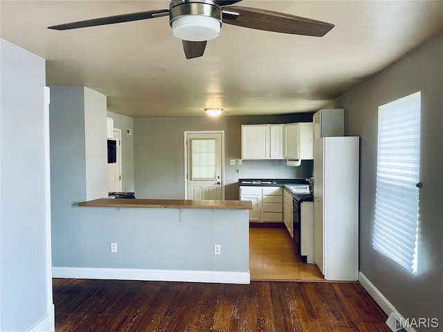 219 2nd St, Winfield, MO 63389 - kitchen featuring ceiling fan, hardwood / wood-style floors, baseboards, and white cabinetry