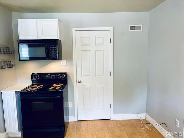 219 2nd St, Winfield, MO 63389 - kitchen featuring black appliances, light wood finished floors, white cabinets, light countertops, and baseboards