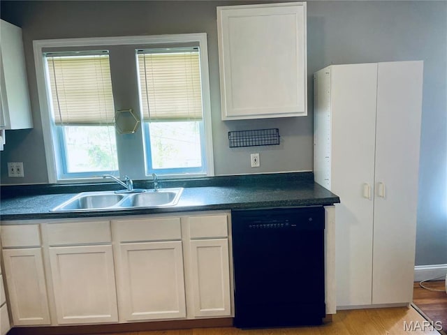 219 2nd St, Winfield, MO 63389 - kitchen featuring black dishwasher, a sink, white cabinetry, and dark countertops
