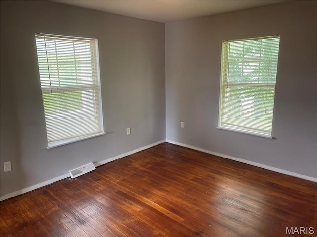 219 2nd St, Winfield, MO 63389 - spare room featuring healthy amount of natural light, hardwood / wood-style flooring, and baseboards