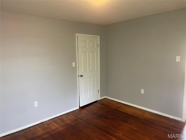 219 2nd St, Winfield, MO 63389 - unfurnished room with baseboards and dark wood finished floors