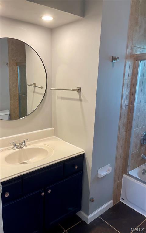 219 2nd St, Winfield, MO 63389 - bathroom featuring vanity, tile patterned flooring, bathing tub / shower combination, and baseboards