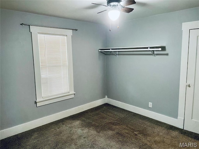 219 2nd St, Winfield, MO 63389 - unfurnished room with dark carpet, a ceiling fan, and baseboards