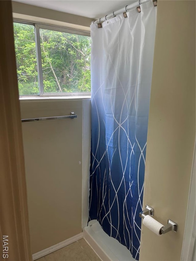 219 2nd St, Winfield, MO 63389 - bathroom featuring a shower with shower curtain and tile patterned floors