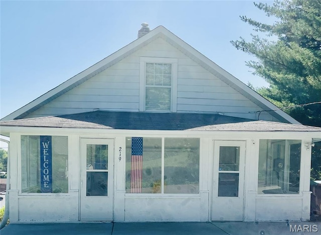 219 2nd St, Winfield, MO 63389 - view of side of home featuring a chimney and roof with shingles