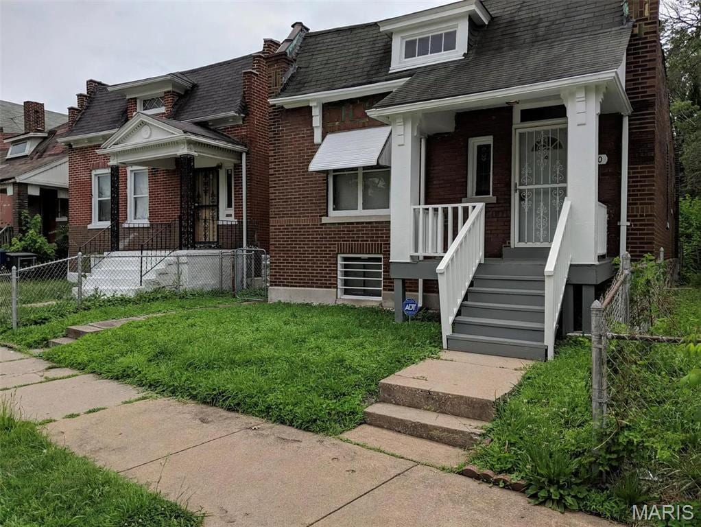 4210 E Carter Ave, Saint Louis, MO 63115 - view of front of home with brick siding and roof with shingles