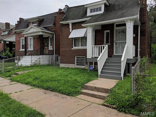 4210 E Carter Ave, Saint Louis, MO 63115 - view of front of home with brick siding and roof with shingles