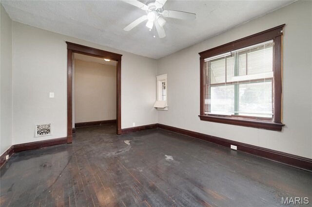 4210 E Carter Ave, Saint Louis, MO 63115 - empty room featuring hardwood / wood-style floors, baseboards, and a ceiling fan