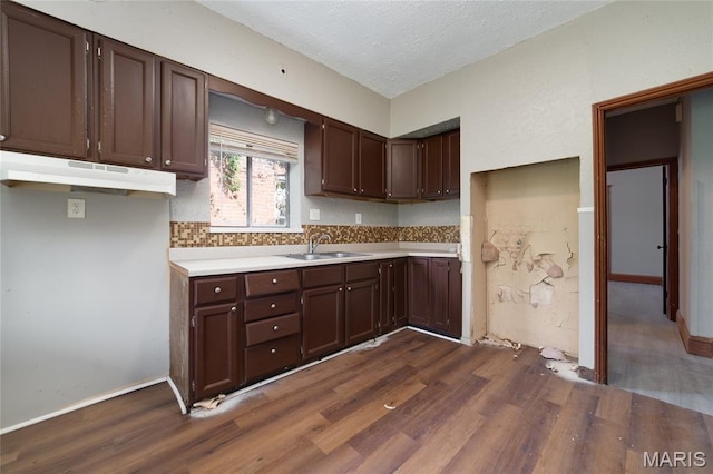 4210 E Carter Ave, Saint Louis, MO 63115 - kitchen featuring a sink, dark wood finished floors, light countertops, dark brown cabinets, and a textured ceiling