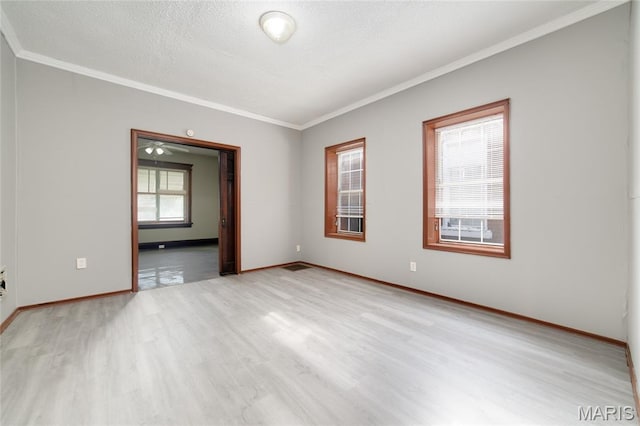 4210 E Carter Ave, Saint Louis, MO 63115 - unfurnished room featuring ornamental molding, light wood-style floors, baseboards, and a textured ceiling