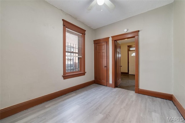 4210 E Carter Ave, Saint Louis, MO 63115 - spare room featuring light wood finished floors, baseboards, and a ceiling fan