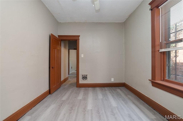 4210 E Carter Ave, Saint Louis, MO 63115 - spare room with light wood finished floors, baseboards, and a ceiling fan