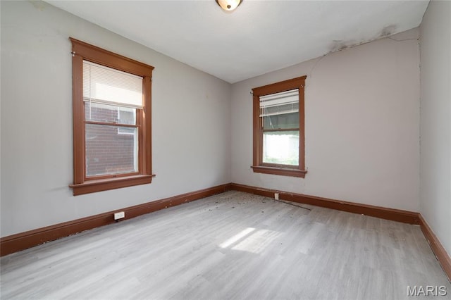 4210 E Carter Ave, Saint Louis, MO 63115 - spare room featuring wood finished floors and baseboards