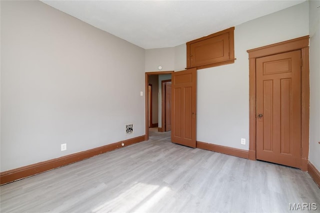 4210 E Carter Ave, Saint Louis, MO 63115 - unfurnished bedroom with light wood finished floors and baseboards