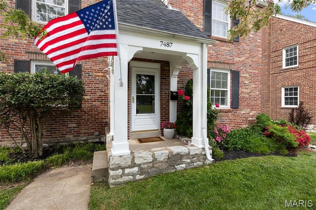 7487 Shaftesbury Ave, University City, MO 63130 - doorway to property with brick siding and a shingled roof