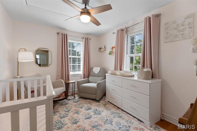 7487 Shaftesbury Ave, University City, MO 63130 - bedroom featuring a crib, a ceiling fan, and baseboards