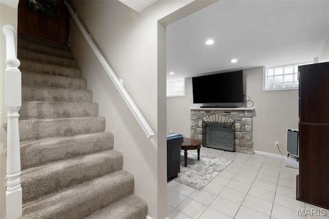 7487 Shaftesbury Ave, University City, MO 63130 - stairs featuring tile patterned flooring, a stone fireplace, recessed lighting, and baseboards