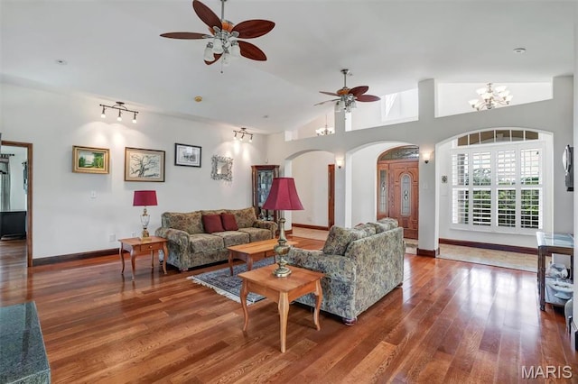 3033 Oakvale Rd, De Soto, MO 63020 - living area featuring a ceiling fan, arched walkways, wood finished floors, baseboards, and lofted ceiling