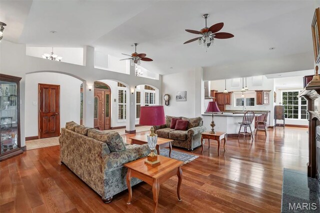 3033 Oakvale Rd, De Soto, MO 63020 - living area with a ceiling fan, arched walkways, hardwood / wood-style floors, and vaulted ceiling