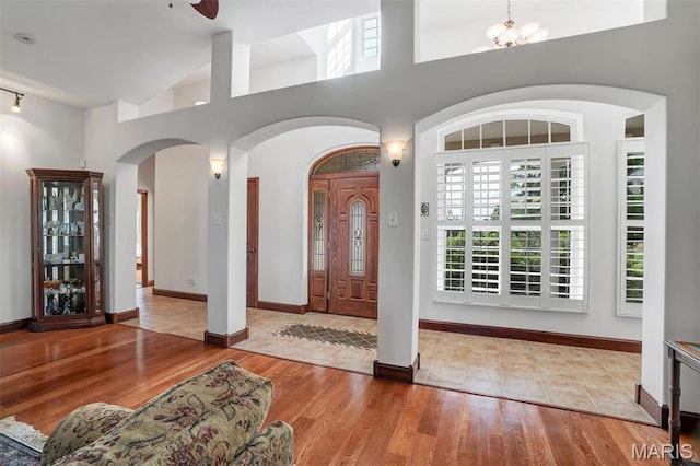 3033 Oakvale Rd, De Soto, MO 63020 - entryway featuring wood finished floors, arched walkways, a towering ceiling, baseboards, and ceiling fan