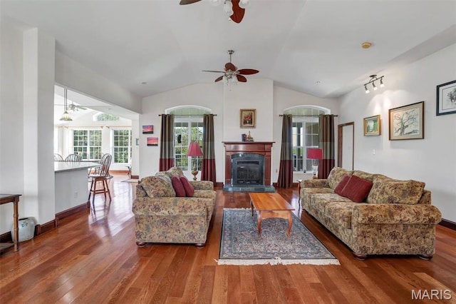 3033 Oakvale Rd, De Soto, MO 63020 - living area featuring ceiling fan, wood finished floors, vaulted ceiling, and a glass covered fireplace