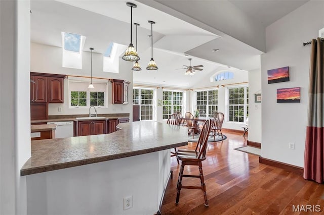 3033 Oakvale Rd, De Soto, MO 63020 - kitchen with a sink, ceiling fan, dark wood-style flooring, a breakfast bar area, and dishwasher