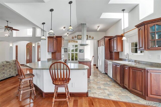 3033 Oakvale Rd, De Soto, MO 63020 - kitchen featuring a sink, white appliances, arched walkways, a kitchen breakfast bar, and a ceiling fan