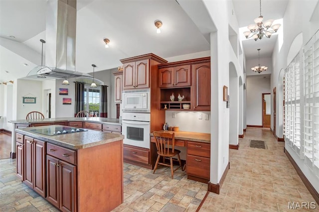 3033 Oakvale Rd, De Soto, MO 63020 - kitchen featuring white appliances, a chandelier, stone tile floors, island range hood, and high vaulted ceiling