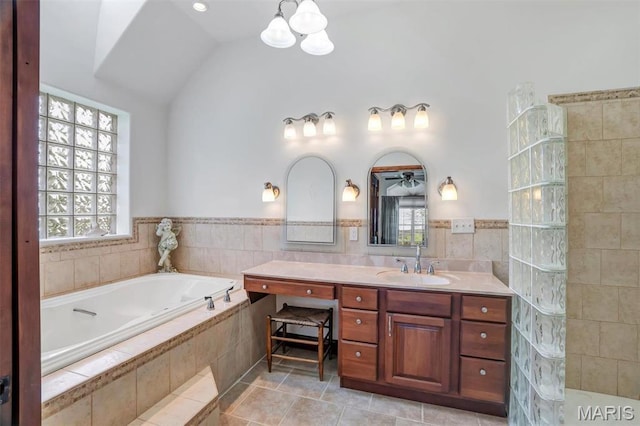 3033 Oakvale Rd, De Soto, MO 63020 - full bathroom with a chandelier, plenty of natural light, vanity, a garden tub, and vaulted ceiling