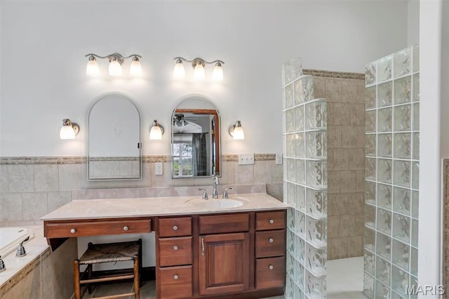 3033 Oakvale Rd, De Soto, MO 63020 - full bathroom with vanity, a walk in shower, tile walls, a wainscoted wall, and a bath