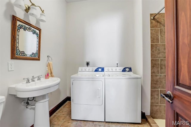 3033 Oakvale Rd, De Soto, MO 63020 - laundry area featuring light tile patterned floors, washing machine and dryer, and baseboards