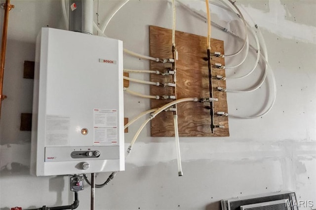 3033 Oakvale Rd, De Soto, MO 63020 - utility room featuring tankless water heater